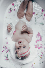 baby in milk with flowers