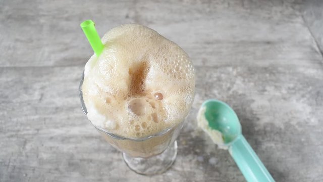 root beer pouring over vanilla ice cream float