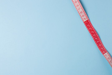 Colorful measuring tapes on blue background