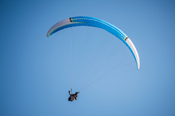 paraglider flying in the blue sky. Italian Alps. Piedmont. Italy