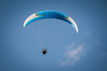 paraglider flying in the blue sky. Italian Alps. Piedmont. Italy
