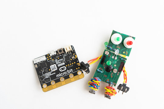 Minsk, Belarus. November, 2019. The BBC robot Micro Bit is near the robot. It can be programming on Scratch and Python. Creative. Connected. Coding. Learning, teaching easy and fun. Free space text.