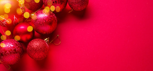 Red New Year or Christmas background and sparkling christmas balls on it.