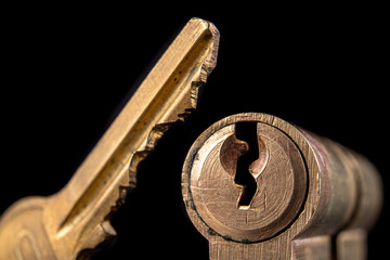 A old door lock on a dark background. A patent and keys to secure the front door.