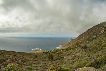 Rocky coastline with sharp cliffs in the ocean on the North of La Gomera island near Arguamul village where you can get along the narrow winding serpatine. Canary Islands, Spain