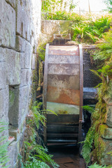 Fototapeta premium Mélisey, France - 10 11 2019: The Baverey barns. Mill wheel