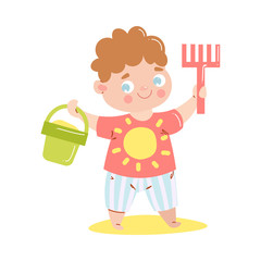 Cute happy smiling baby in red t-shirt standing and holding a rake and the bucket with sand. Vector illustration in flat cartoon style.