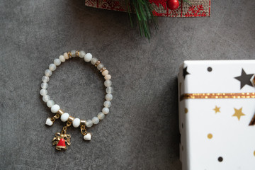 High angle on the crystal handmade bracelet white perls by the gift box on the table