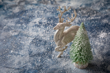 Green small christmas fir and silver deer