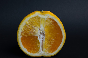 slices of juicy orange on a black background