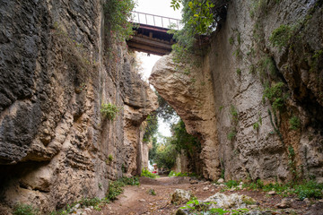 path between high stone walls to titus vespasianus tunnel which is the first hand made tunnel in the world