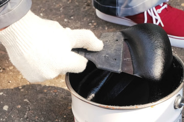 Bituminous mastic on spatula. building mixtures and coatings.