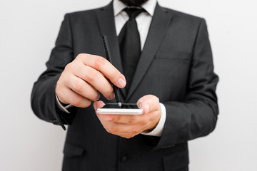 Male human wear formal work suit hold smart hi tech smartphone use one hand