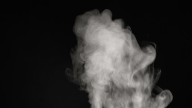 A stream of white steam or smoke close-up on a black background