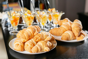 Breakfast buffet. Fresh pastry, crispy morning croissants, breakfast in hotel. Dessert fruit cocktail in cups