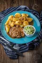 Braised meat in sauce served with boiled potatoes.