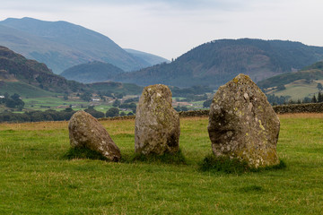 Three stones of the Castlerigg Stone Circle over looking a valley in the Lake District