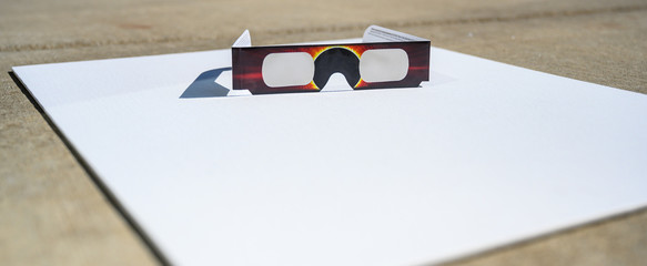 Cheap Solar eclipse shade glasses on white board