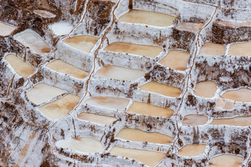 Fototapeta na wymiar Landscape of the salt terraces of Maras ( Salineras de Maras) in the Andes mountain range in the region of Cusco, Peru, Sacred Valley. One of the main tourist attractions in Cusco Region.