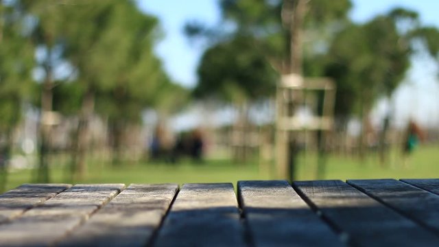 Empty table covered with sackcloth over blurred trees with bokeh background, product display template