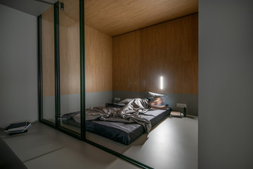 Trendy modern interior with gray podium with sleeping place