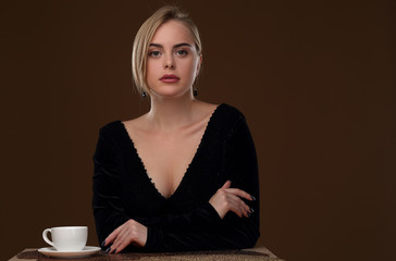 Beautiful girl in a black dress with a deep neckline