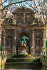 Fototapeta na wymiar Paris Medici fountain (La Fontaine Medicis, 1630) a monumental fountain with sculptures Polyphemus Surprising Acis and Galatea at Luxembourg Gardens. Paris, France.