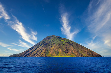 Volcanic island Stromboli in Lipari viewed from the ocean with nice clouds, Sicily - 305802853
