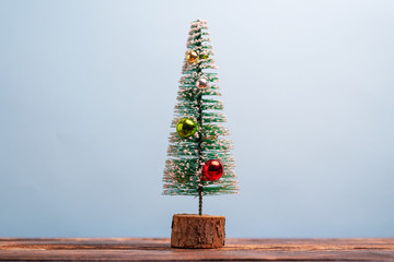 Christmas tree in miniature with decorations and plenty of copy space