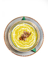 Creamy decorated vegetable soup in a rustic bowl 