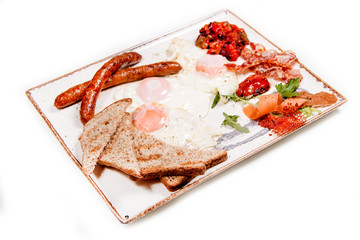 Breakfast meal made of eggs, sausages, decoration and toasted bread