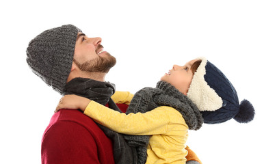 Happy father and son in warm clothes on white background. Winter vacation