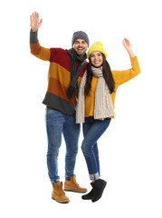 Obraz premium Happy young couple in warm clothes on white background. Winter vacation