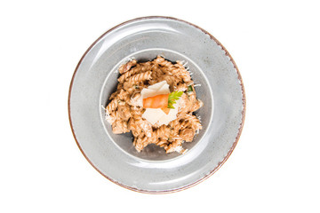 Homemade pasta with chicken, cheese and piece of carrot in a rustic plate