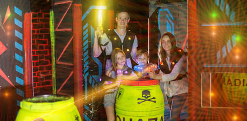 Parents and children playing laser tag in beams