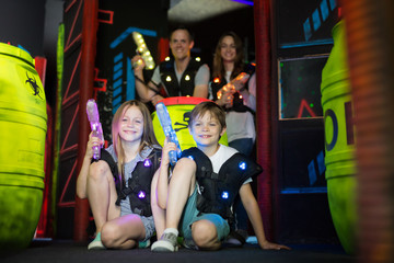 Obraz na płótnie Canvas Kids sitting with laser guns