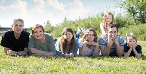 Friendly family taking photos on the lawn