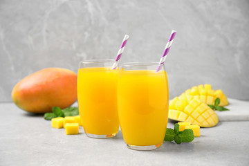 Fresh delicious mango drink on light table