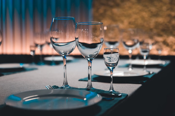 table setting with shiny wineglasses in restaurant