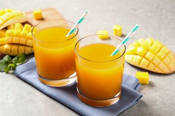 Fresh delicious mango drink on light table