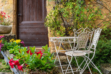 Cosy garden near the old stone house in the village. Beynac-et-Cazenac. France. Decoration of the...