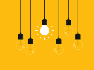 Naklejka premium Set of hanging light bulbs with one glowing. Leadership, power and uniqueness concept.