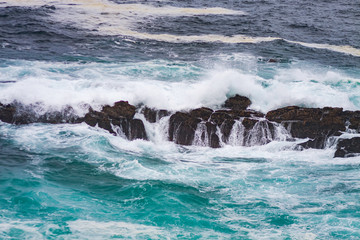 SEA LANDSCAPE WITH WAVES SUCKING AGAINST ROCKS IN THE NORTH OF SPAIN