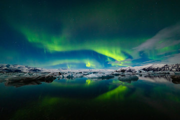 Fototapeta na wymiar Aurora Borealis over a glacier lagoon in Iceland