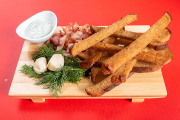 Beer croutons with garlic, sauce and herbs.
