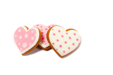 Background from pink cookies heart shaped with different patterns, isolated