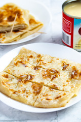 Layered Banana flatbread served with condensed milk