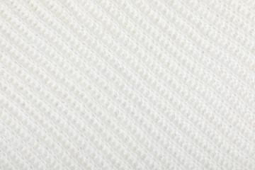 Knitted wool texture background. White knitted warm winter sweater. Winter concept. Flat lay, top view, copy space
