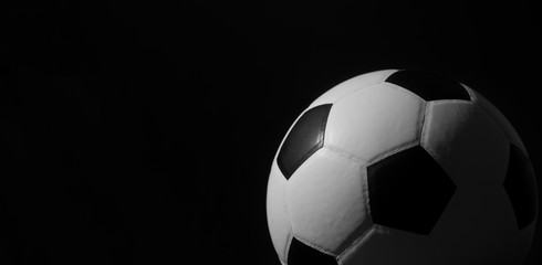 Fototapeta na wymiar Closeup of football ball on black background