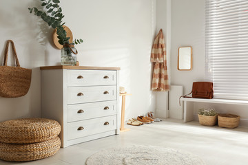 Chest of drawers in stylish room interior